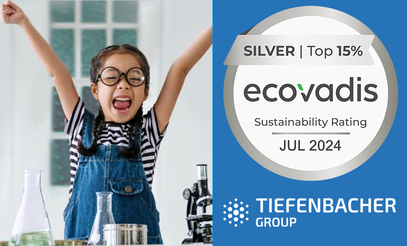 Tiefenbacher Group - A smiling child with raised arms stands beside science equipment. Next to her is a badge reading "Silver | Top 15% ecovadis Sustainability Rating Jul 2024." The Tiefenbacher Group, a family-owned pharmaceutical company, logo appears at the bottom.
