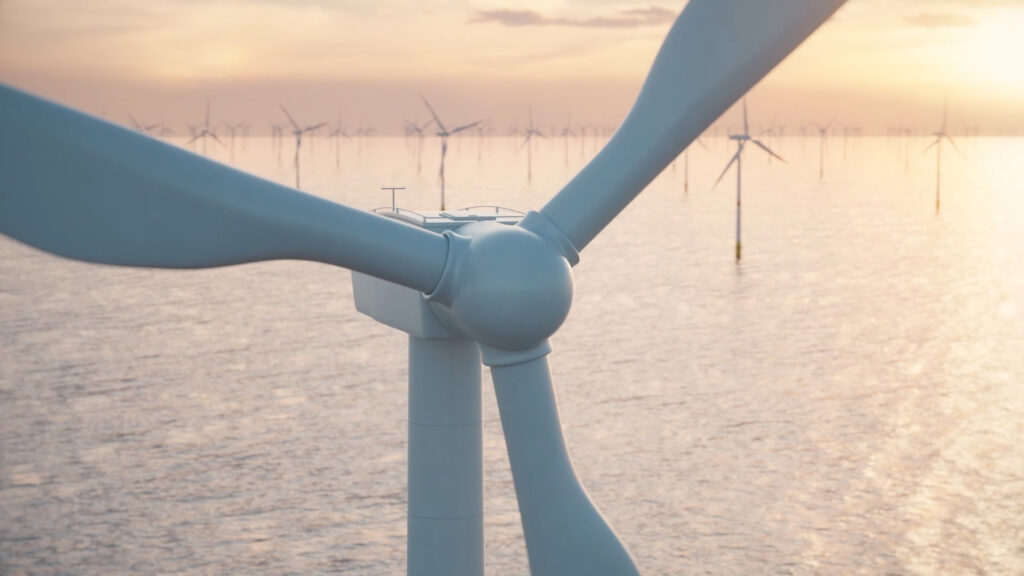 Tiefenbacher Group - Close-up of a wind turbine at sea during sunset, with other turbines in the background. The warm sky reflects off the ocean, echoing the innovative energy found in pharmaceutical healthcare solutions.